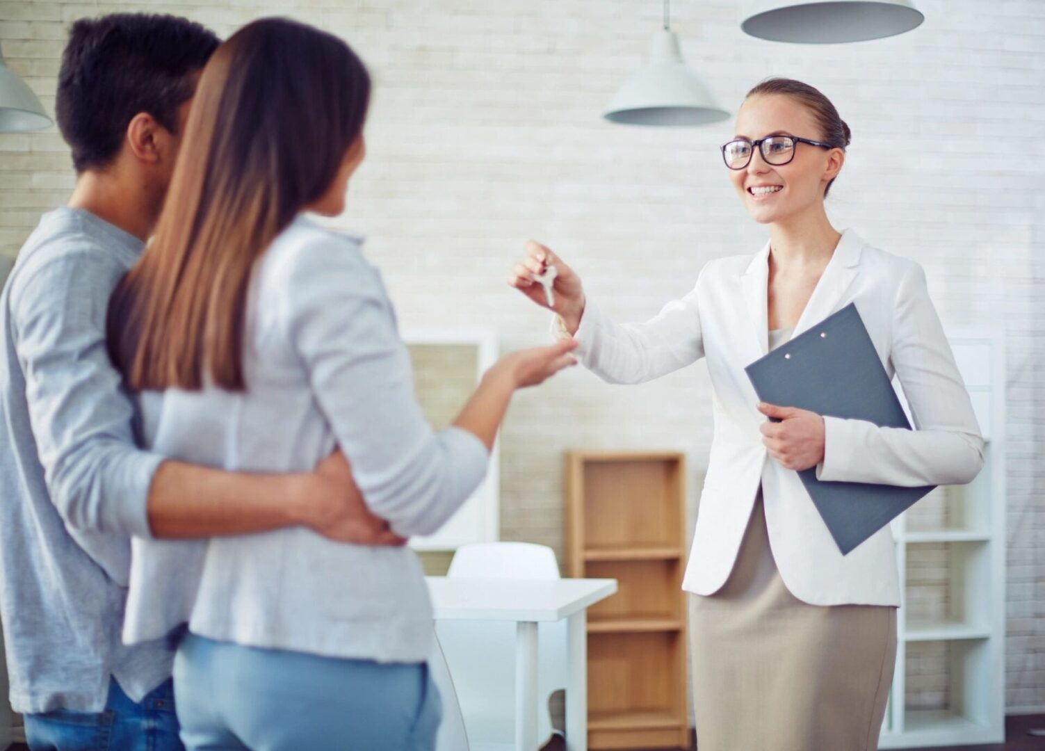 A woman is shaking hands with two other women.